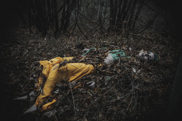 dead girl in autumn foliage wearing green and yellow robes