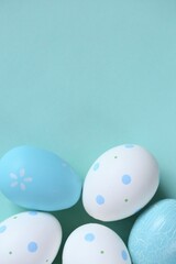 Easter holiday.Easter blue and white speckled eggs set on  blue background.Spring festive easter background in pastel colors