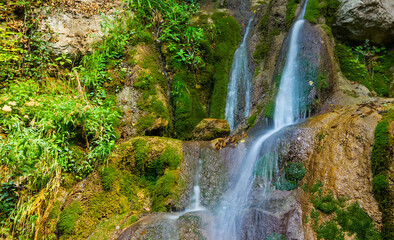 Fototapeta na wymiar small waterfall on the mountain river