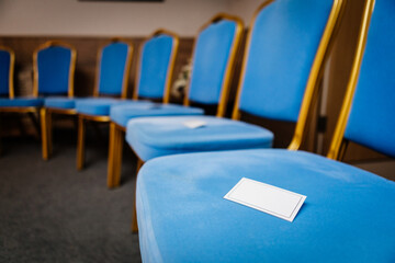 There are soft blue chairs with pages for a conference, a master class or the organization of an event