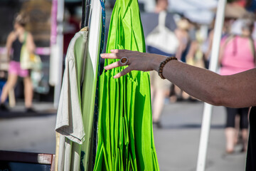 Reusable shopping bags at outdoor market against blurred shoppens - Motion blur hand reaches for them