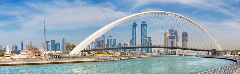 Dubai -  The skyline with the arched bridge over the new Canal and Downtown.
