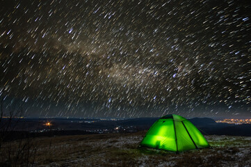 Long exposure tent against the background of the starry sky