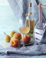 Wine and fruits on a wooden table, gray linen napkin, home cooking