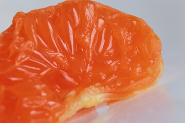 macro photo mandarin slices in a white plate close up several pieces of lie on the table background out of focus