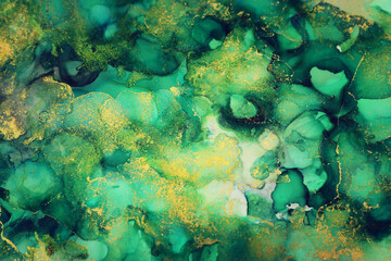 art photography of abstract fluid art painting with alcohol ink, green and gold colors