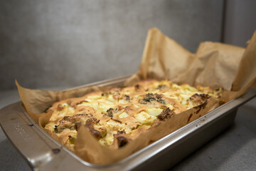 Delicious baked broccoli casserole took out of the oven with grey background