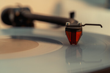 Close-up of turntable pick-up and needle playing a bright vinyl record © Manuel
