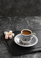 Turkish Coffee with traditional porcelain cup. Coffee presentation with Turkish delight.