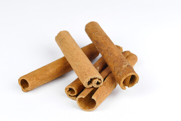 cinnamon sticks in the foreground, white background, spices, isolated