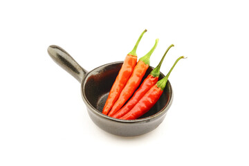 composition of hot peppers in a black bowl glass bowl on a white background
