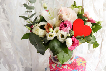 Happy Valentine's Day greeting card. flowers and red heart on a white background. space for text 