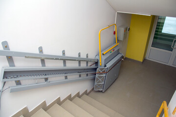 Stairlift for lifting disabled people in a public building. Mechanism for people with disabilities