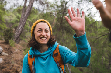 Fototapeta premium A woman with a backpack greets a friend