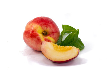 Fototapeta na wymiar Peach fruit half with leaf isolated on white background.