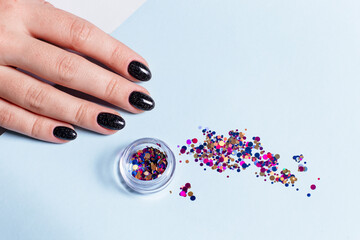 Set of cosmetic tools for manicure and pedicure on an blue background. Manicure, glitter, top view.