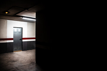 Aluminum door of a storage room in a community garage, image with dark copy space.
