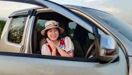 Young woman enjoy life sitting in car of travel holiday weekend.