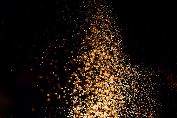 Fototapeta premium a lot of orange splashes backlit with light on a black background.