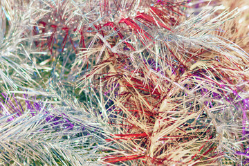 Christmas tree colorful tinsel lies on the floor