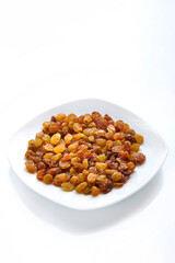 Dried sweet golden raisins on isolate on white background copy space.
