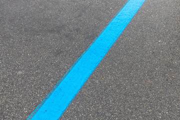 blue parking strips on asphalt road