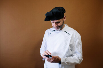 Male chef using a smart phone