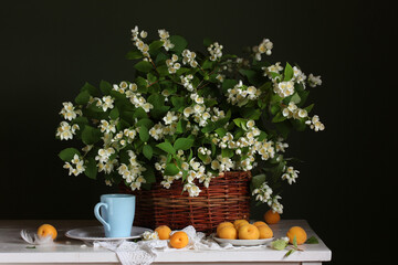 Obraz na płótnie Canvas blooming jasmine branches in a basket. white flowers.