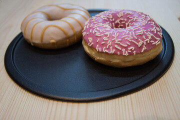 Donut with colorful sprinkles isolated on white background. Top view.