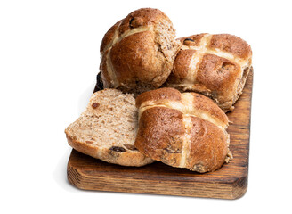 Easter wholemeal hot cross buns on wooden board isolated on white background