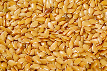 close up of sesame seeds on wooden spoon