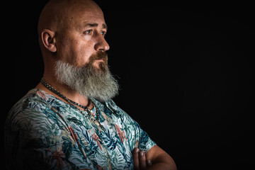 close up, portrait of emotional, thoughtful, handsome positive young bearded businessman man. Low key isolated on dark background. Body language 