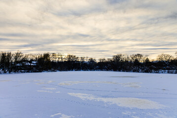 Fototapeta na wymiar Landscape on a frozen river in a winter evening