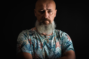 close up, portrait of emotional, thoughtful, handsome positive young bearded businessman man. Low key isolated on dark background. Body language 