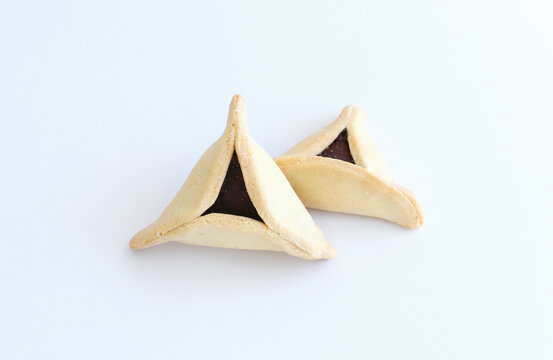 Purim celebration concept (jewish carnival holiday). Traditional cookie isolated on white