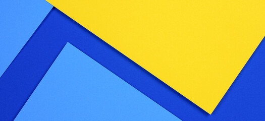 Creative abstract blue and yellow color geometric paper compositon background, top view