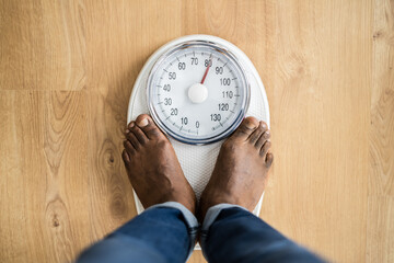African Man Feet Standing On Weight Scale