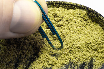 weed grinder full of hemp trichomes of dry medical marijuana flower buds macro image