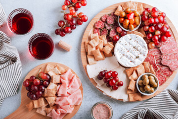 Mediterranean charcuterie board with various kinds of snacks for sharing on concrete background,...