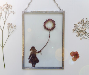 Girl with air balloon, framed pressed flowers in tiffany technique in stained glass
