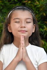 Fototapeta premium Young Philippina Girl In Prayer Closeup