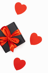 Black gift box with red bow with red hearts isolated on white. Holiday web banner.