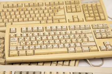 An old dirty computer keyboard isolated on a white background.