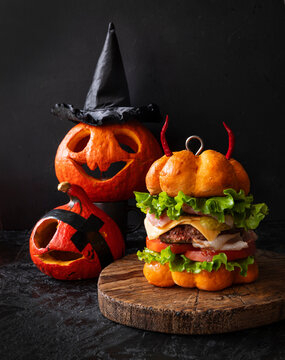 Funny pumpkin burger with a big cutlet. Halloween