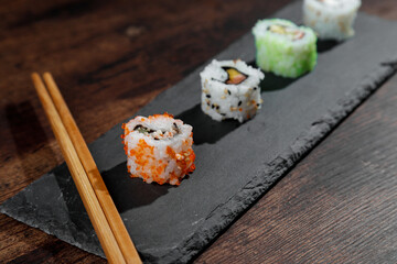 maki on gray plate and wooden table © jonarrillaga