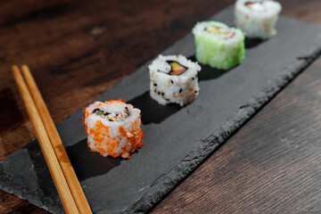 maki on gray plate and wooden table