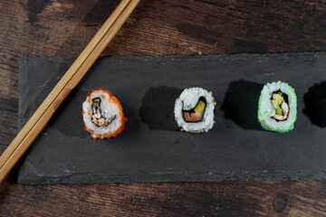 maki on gray plate and wooden table