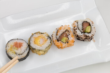 White plate with variety of sushi in portrait