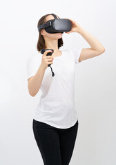 .Young woman in white short in virtual reality (VR) glasses. New generation wireless headset and system.  Isolated on white background © Anna
