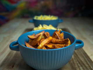 homemade serving of fries. French fries in a bowl on a wooden table.